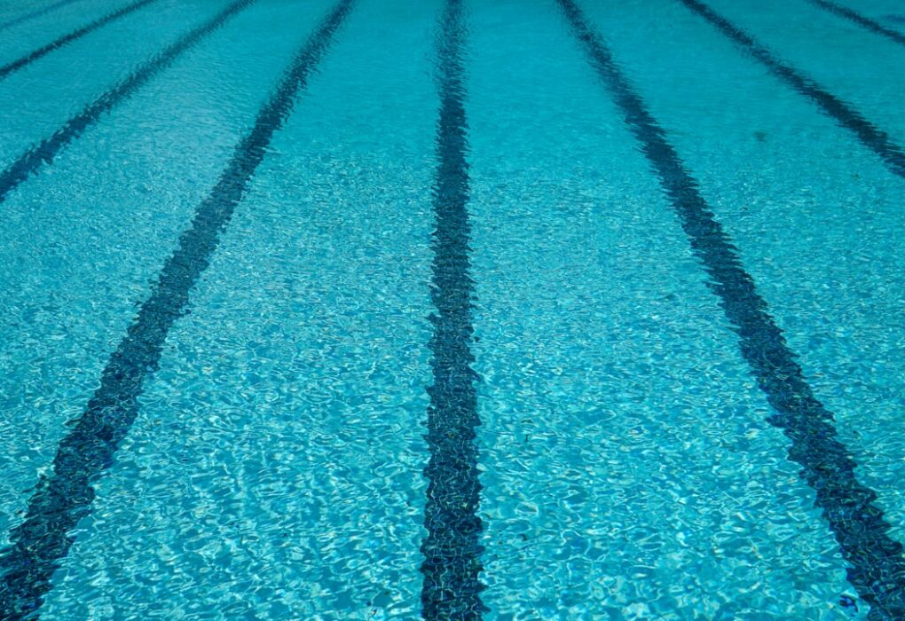 Close-up of clear swimming pool water with lane markings