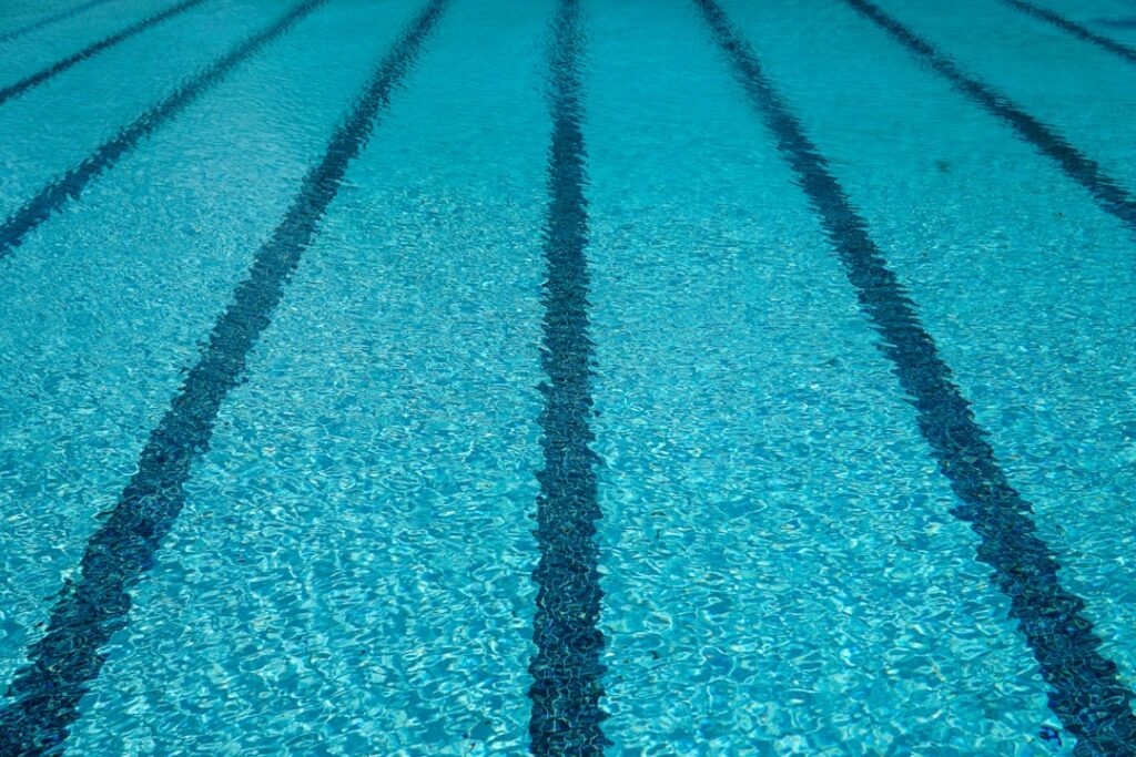 Close-up of clear swimming pool water with lane markings