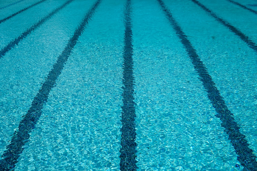 Close-up of clear swimming pool water with lane markings